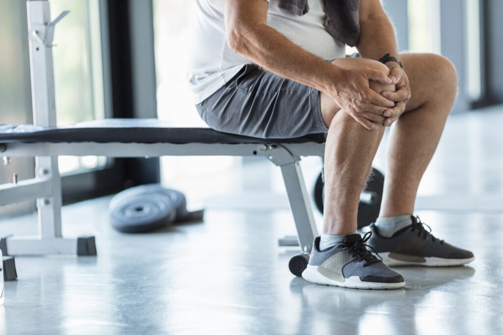 Active senior in gym with knee injury